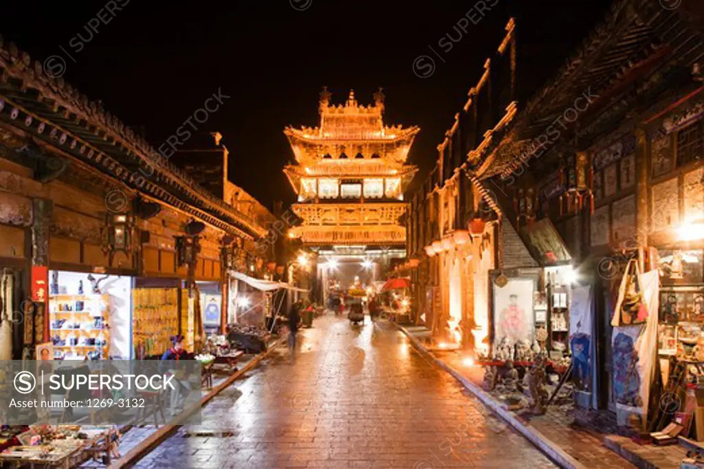 City tower and Southern Main Street lit up at night, Pingyao, Shanxi Province, China