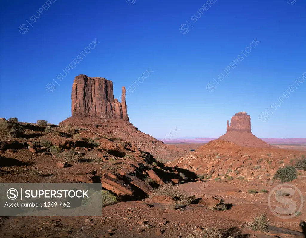 Rock formations on an arid landscape, Mittens Buttes, Monument Valley, Arizona, USA