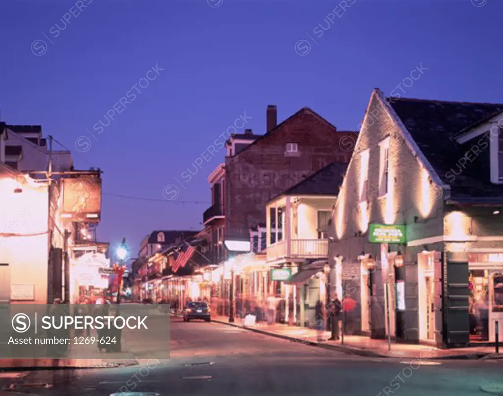 Buildings along a road lit up at night, Bourbon Street, New Orleans, Louisiana, USA