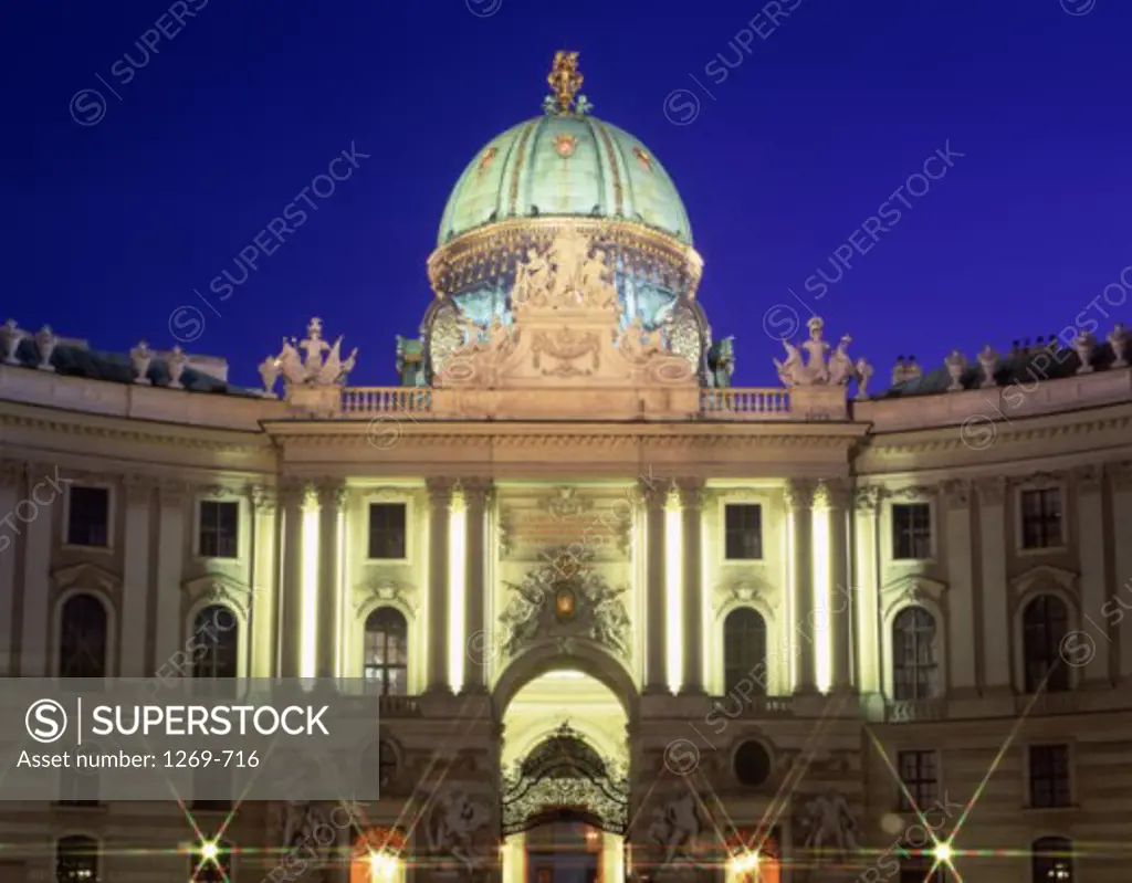 Ancient building lit up at night, Hofburg, Vienna, Austria