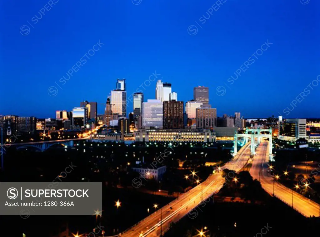 Buildings in a city lit up at night, Minneapolis, Minnesota, USA