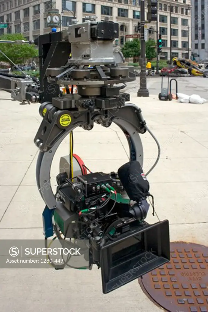 Close-up of a movie camera attached to a long crane near the intersection of Wacker Drive and Wabash Avenue, Chicago, Illinois, USA