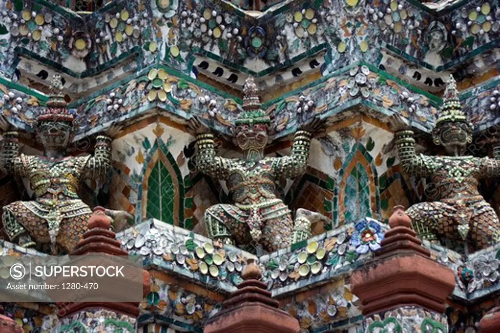 Thailand, Bangkok, Wat Arun, Statues on facade of temple