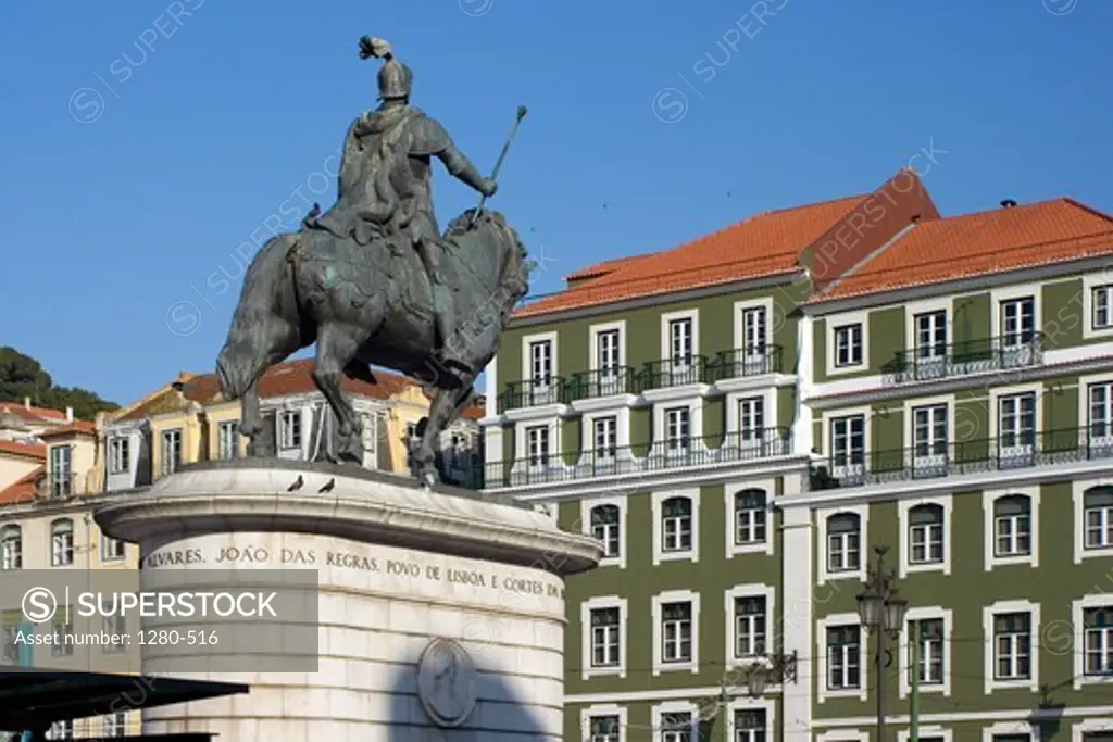 Statue at Figueira Circle with commercial buildings in the background, Lisbon, Portugal