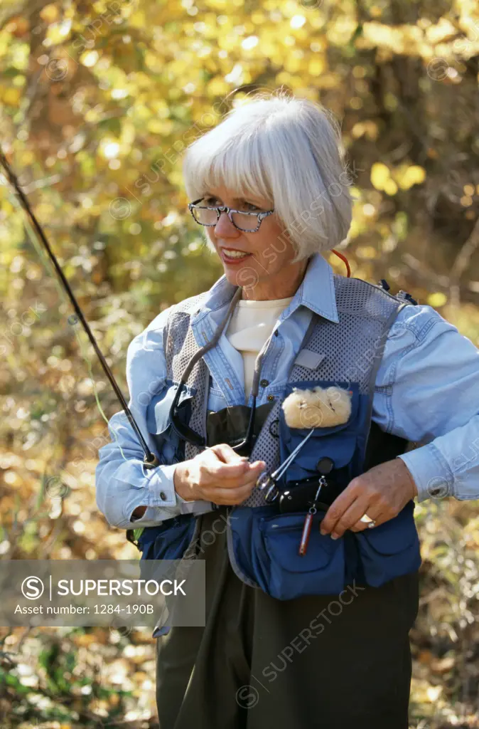 Senior woman preparing for fishing