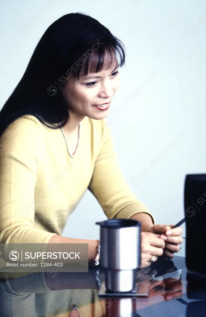 Businesswoman working on desktop PC,