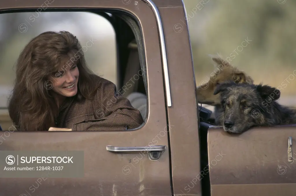Woman with her dog in a pick-up truck