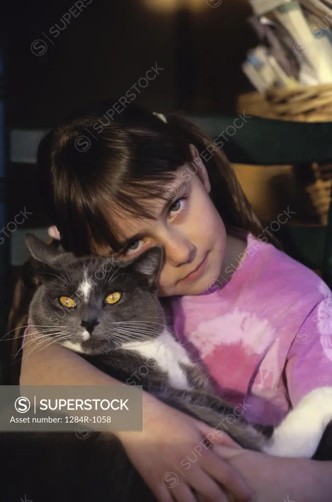 Portrait of a girl holding a cat