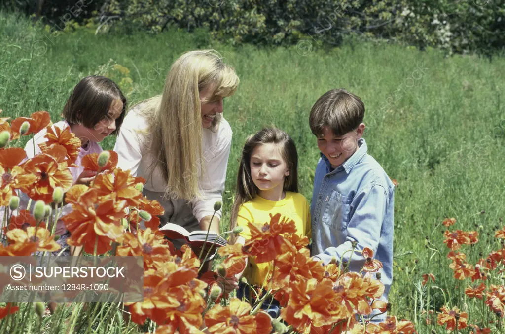 Mother and her three children looking at flowers
