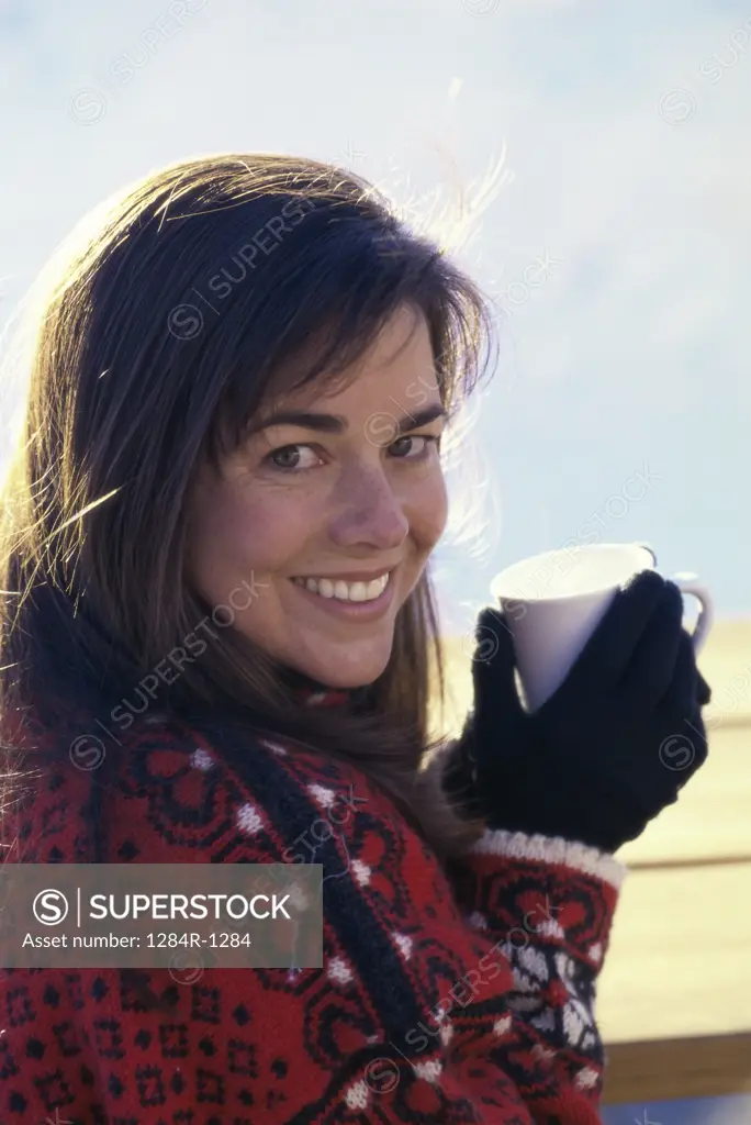 Portrait of a woman holding a hot drink in a cup