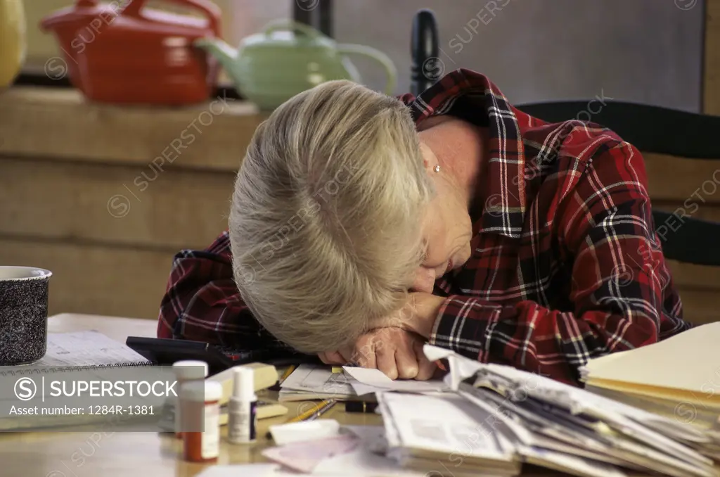 Woman with her head down on a table