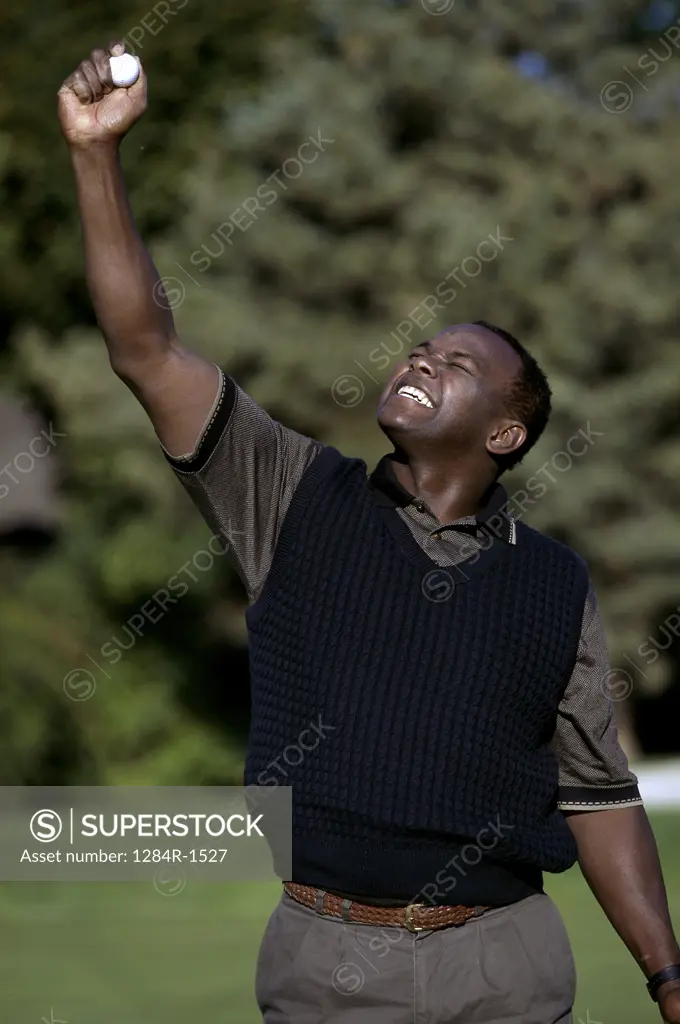 Young man celebrating on a golf course