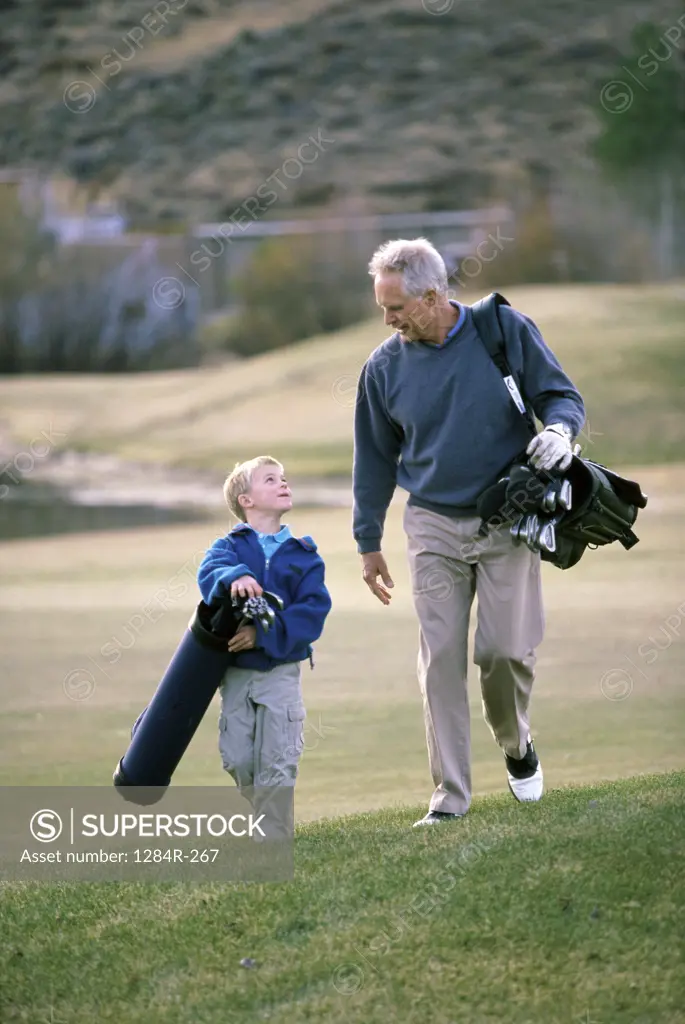 Grandfather and his grandson at a golf course
