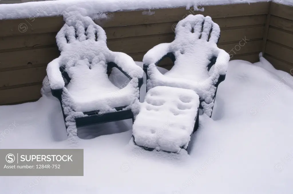 Chairs covered in snow
