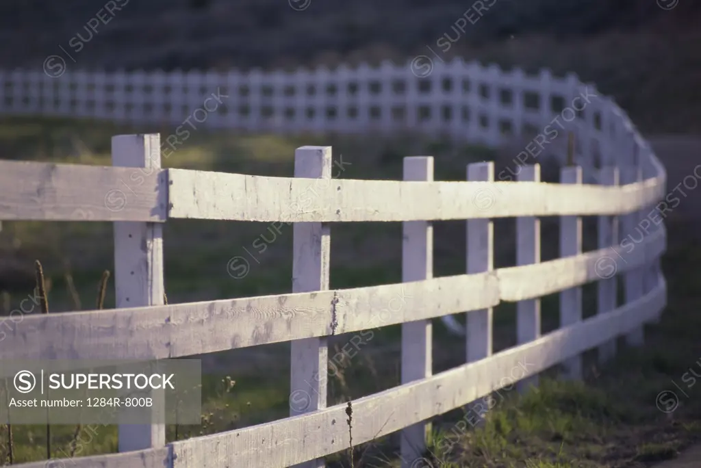 Wooden fence alongside a road