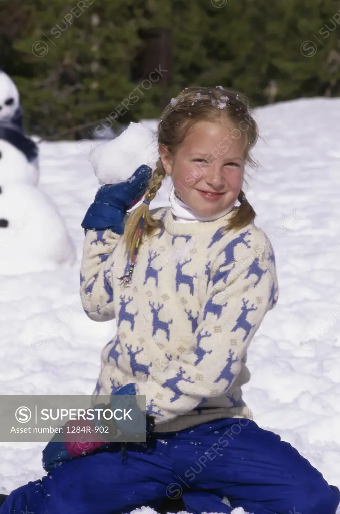 Portrait of a girl playing in the snow