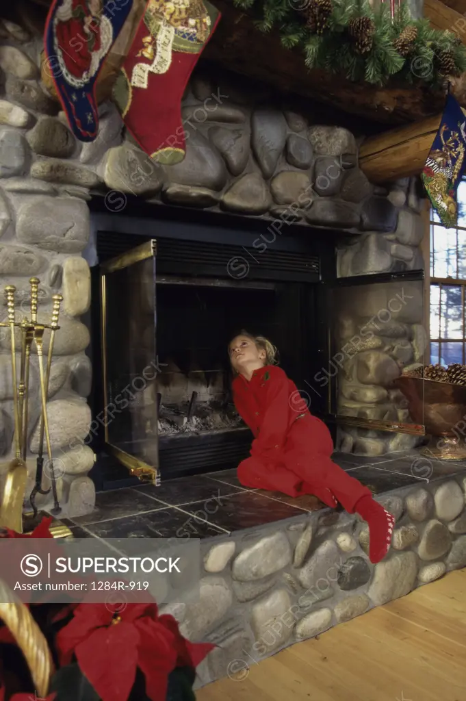 Girl looking up into a fireplace
