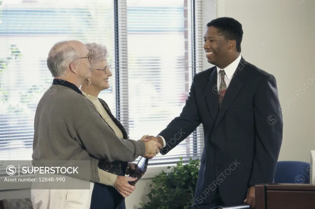 Businessman shaking a senior man's hand