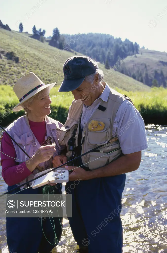 Senior couple holding fishing rods