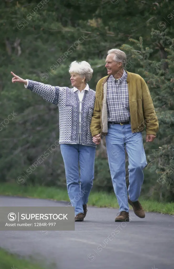Senior couple walking together holding hands