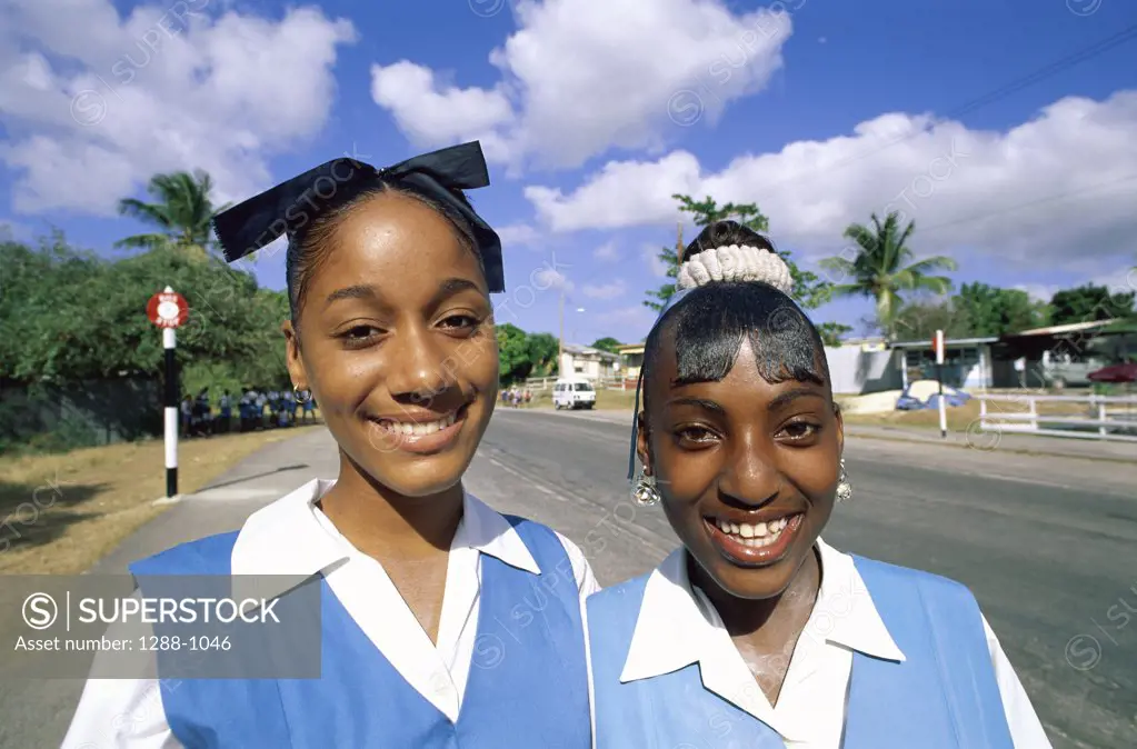 Close-up of two teenage girls smiling, Barbados