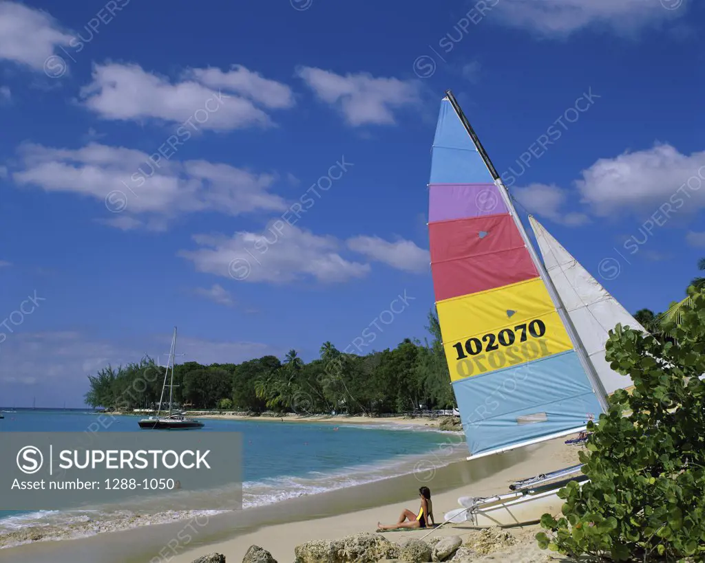 Woman sunbathing on the beach, Holetown Beach, Bridgetown, Barbados