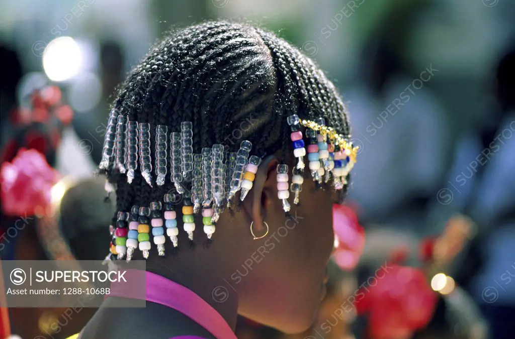Side profile of a teenage girl wearing beads, St. Lucia