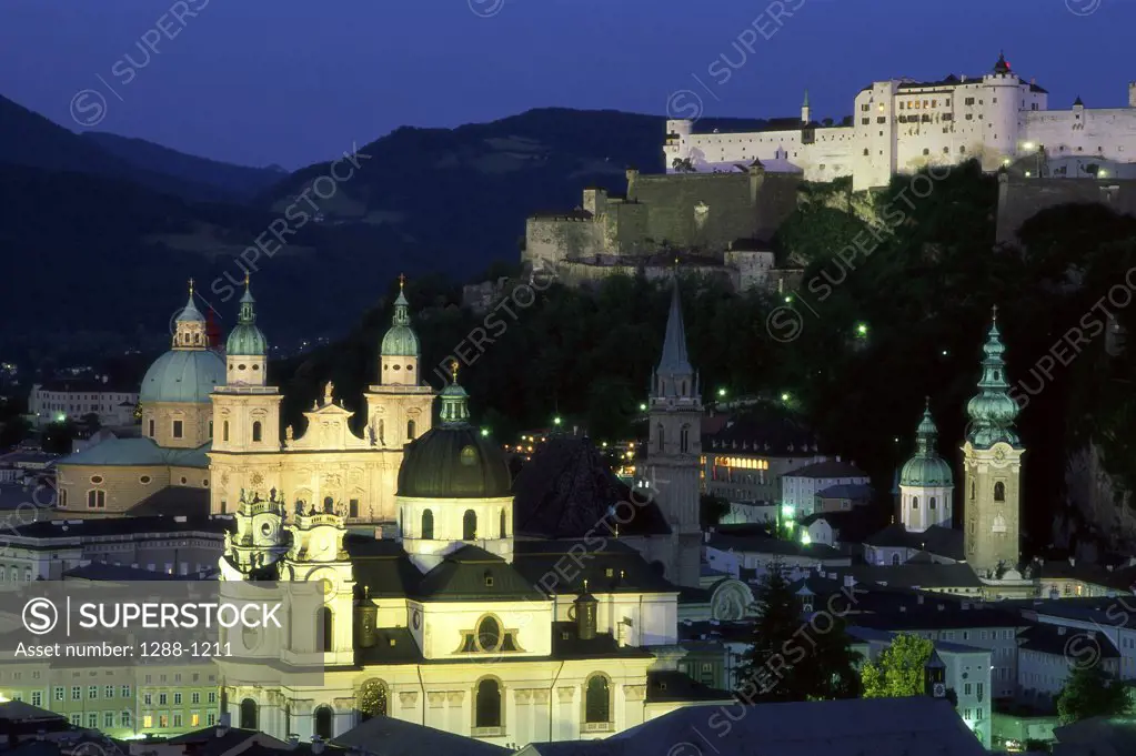 High angle view of buildings lit up at night, Salzburg, Austria