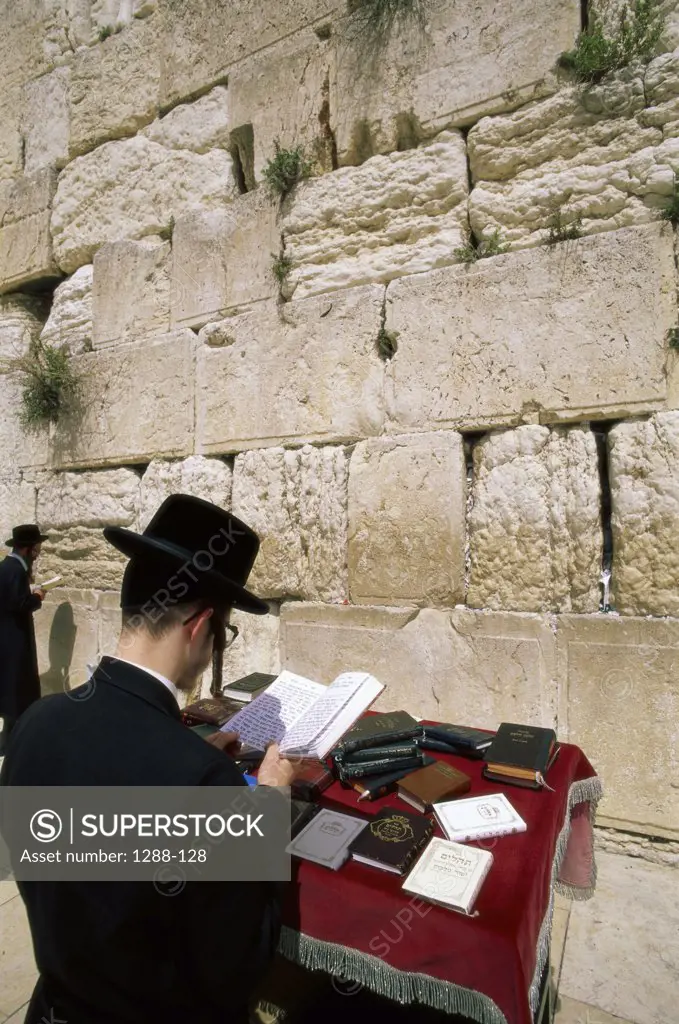 Rear view of a man praying at the Wailing Wall, Jerusalem, Israel