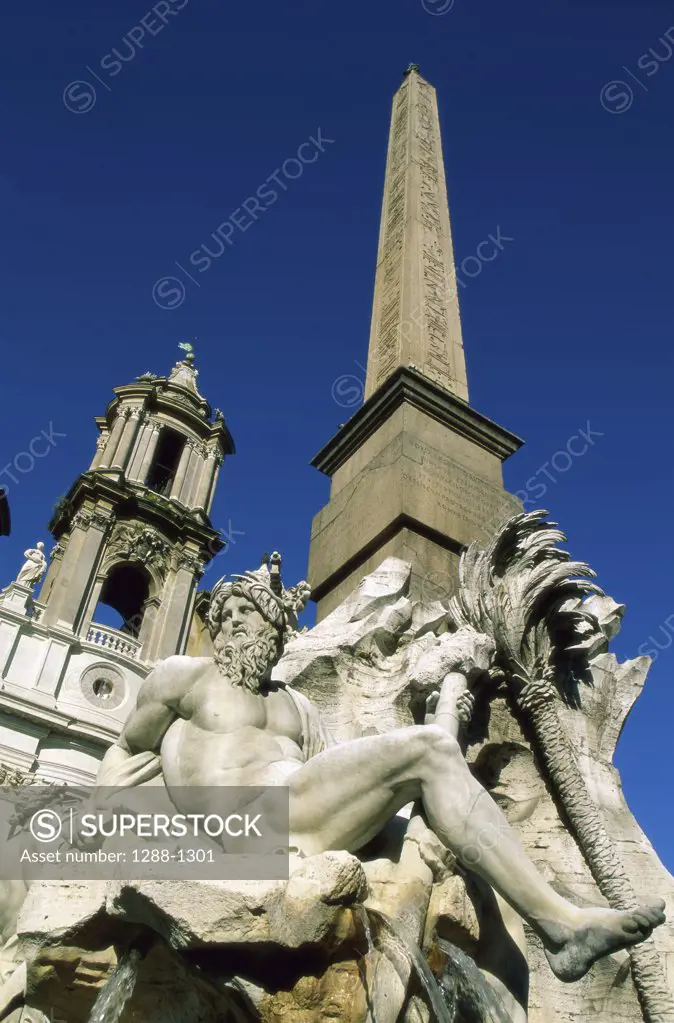 Low angle view of a fountain, Fountain of the Four Rivers, Piazza Navona, Rome, Italy