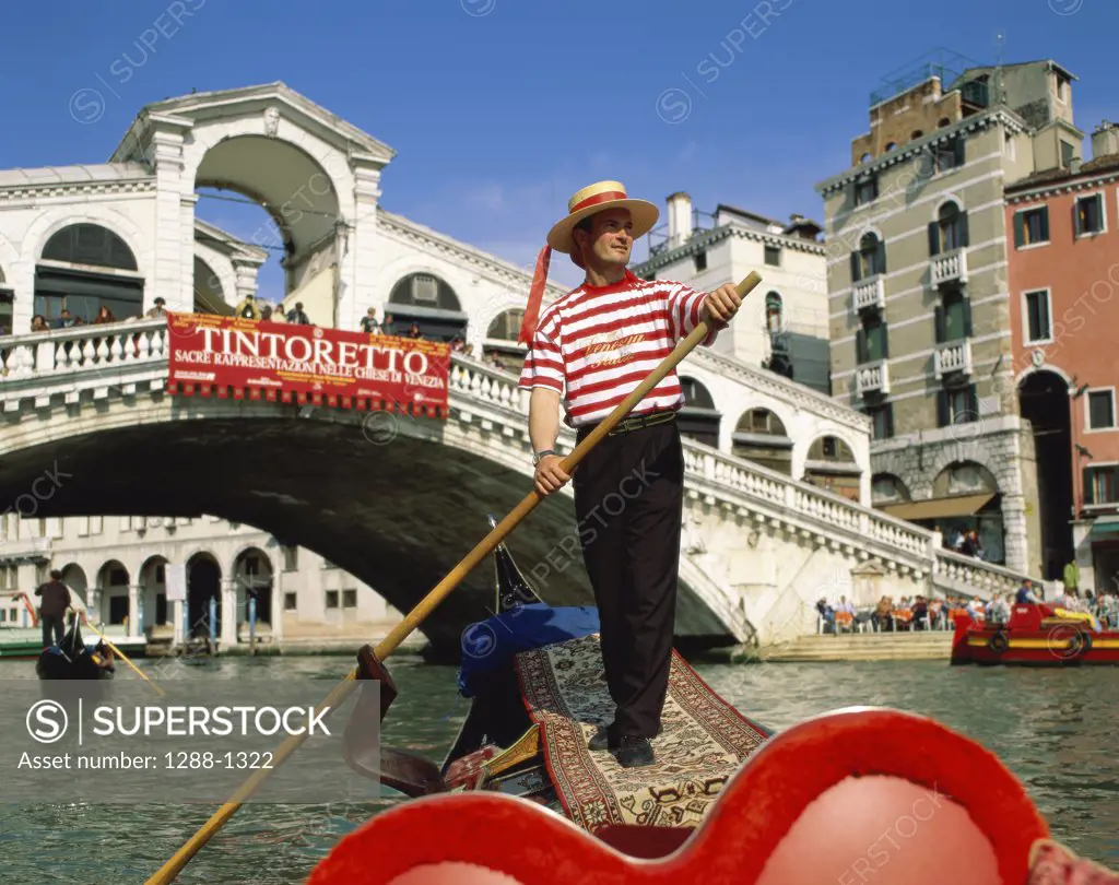 Low angle view of a gondolier, Grand Canal, Venice, Italy
