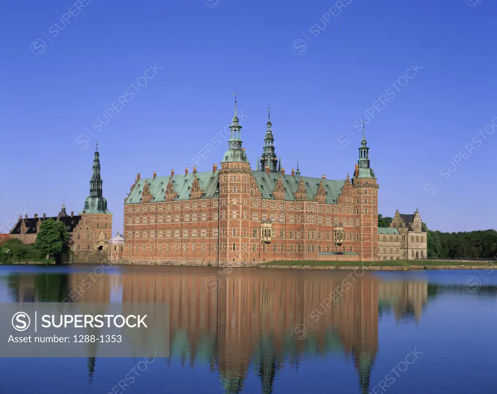 Reflection of a castle in a lake, Frederiksborg Castle, Hillerod, Denmark