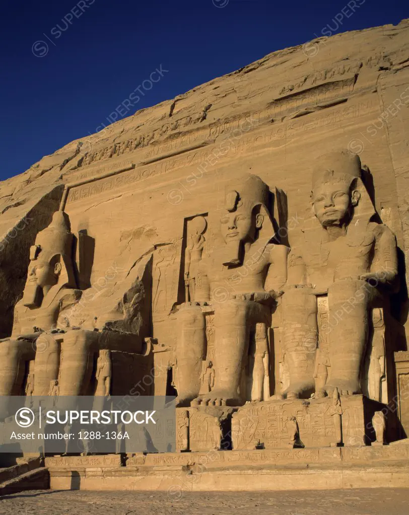 Statues in front of a wall, Great Temple of Ramses II, Abu Simbel, Egypt