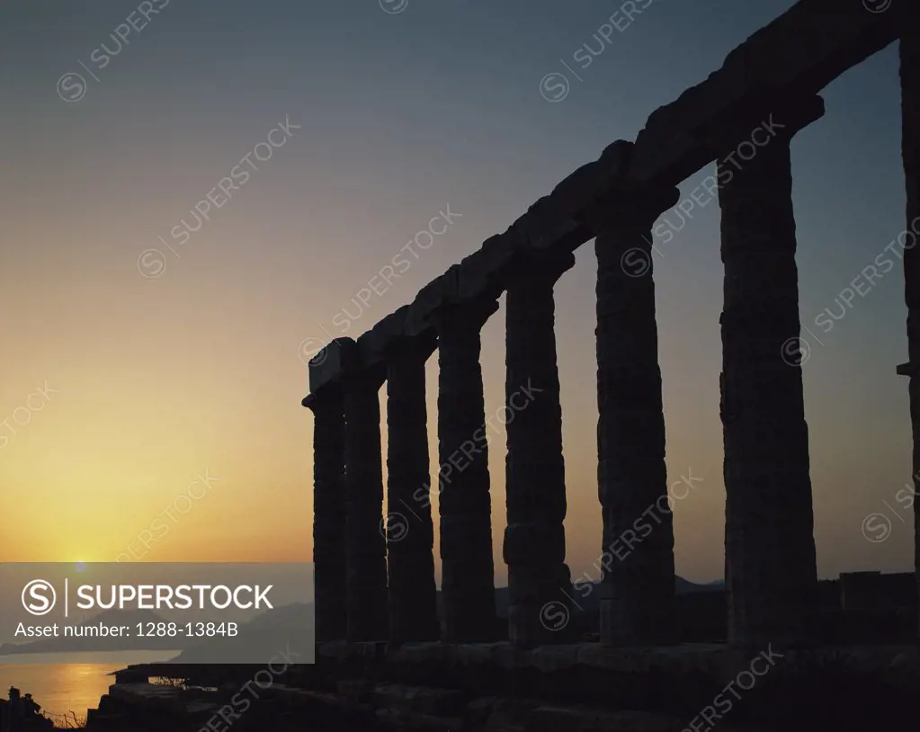 Silhouette of an ancient temple at sunset, Temple of Poseidon, Sounion, Greece