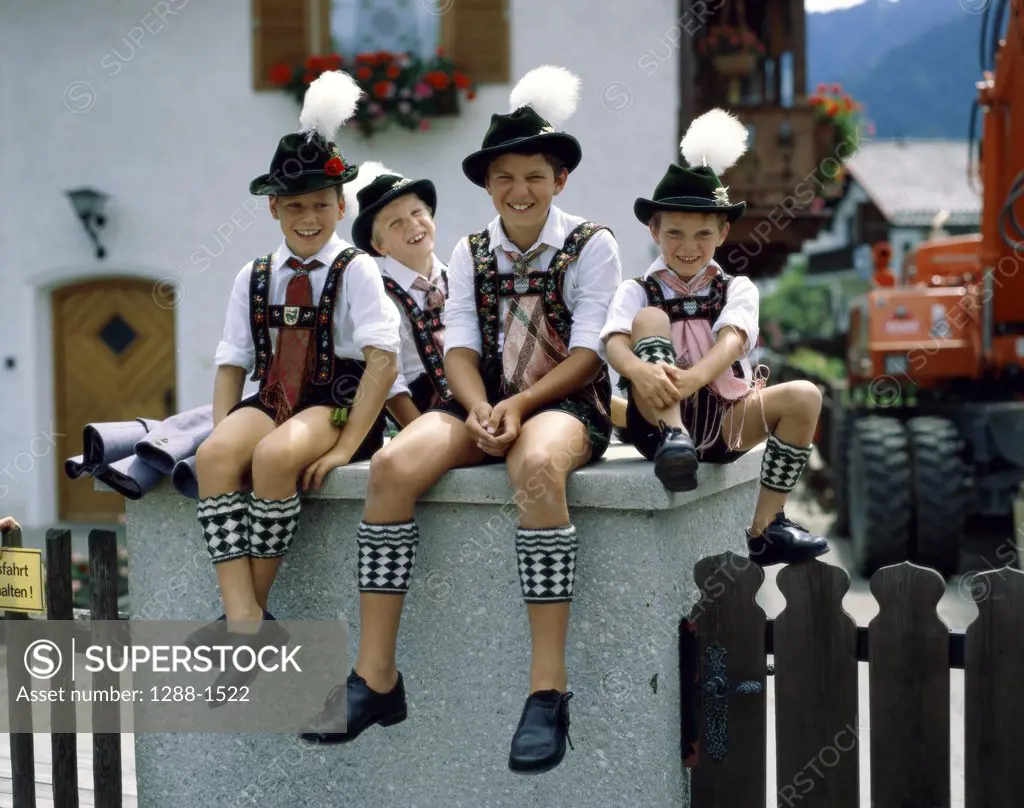 Portrait of boys sitting in a Bavarian festival, Bavaria, Germany
