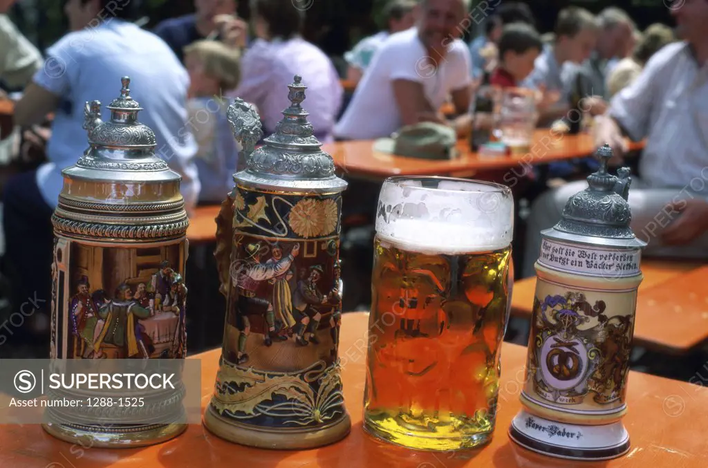 Close-up of beer steins and a beer glass, Bavaria, Germany