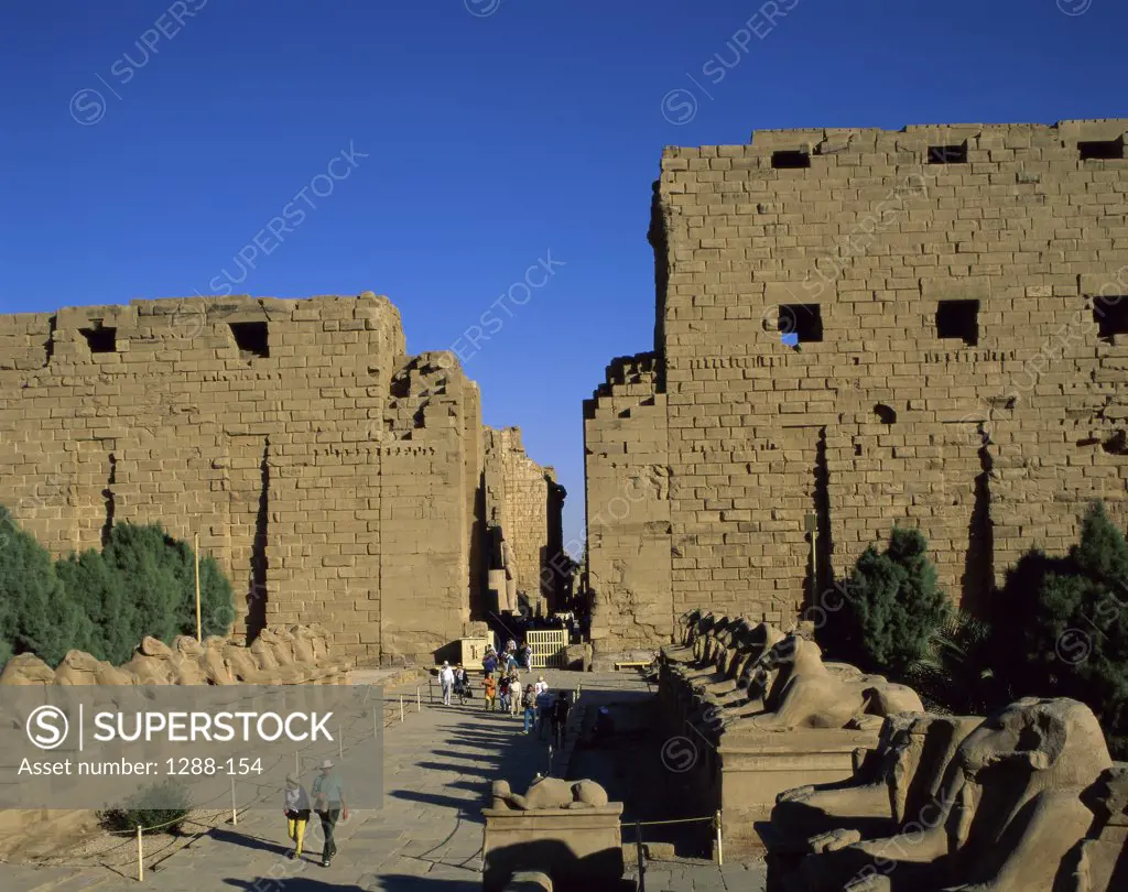 Tourists in a temple, Avenue of the Sphinxes, Temples of Karnak, Luxor, Egypt