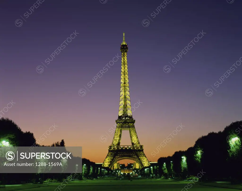 Low angle view of the Eiffel Tower lit up at night, Paris, France