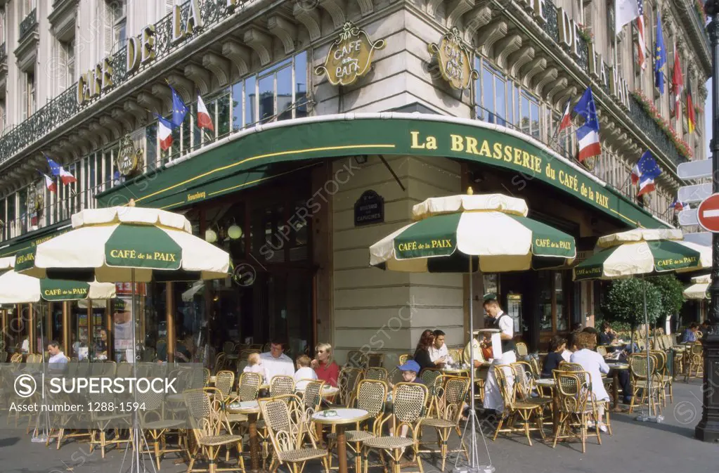 Group of people sitting at a sidewalk cafe, Paris, France