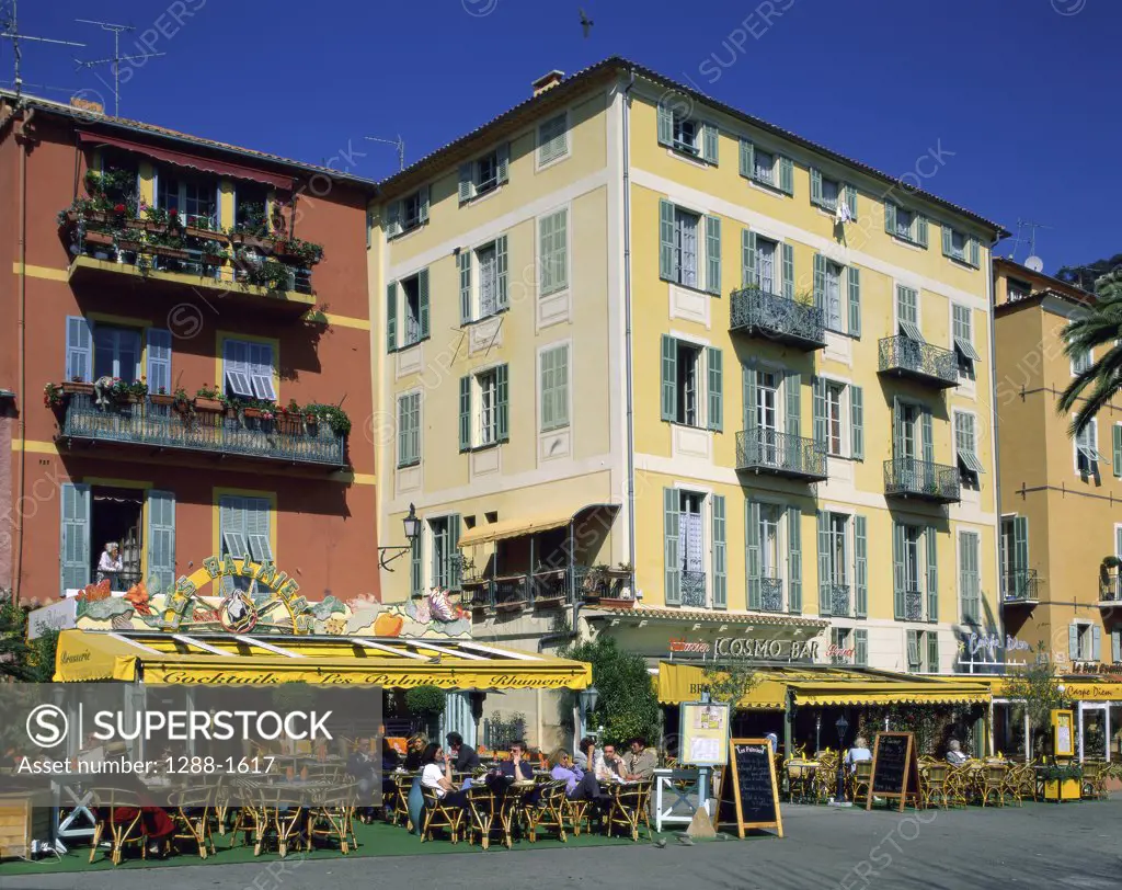 Group of people sitting at a sidewalk cafe, Villefranche-sur-Mer, Cote d'Azur, France