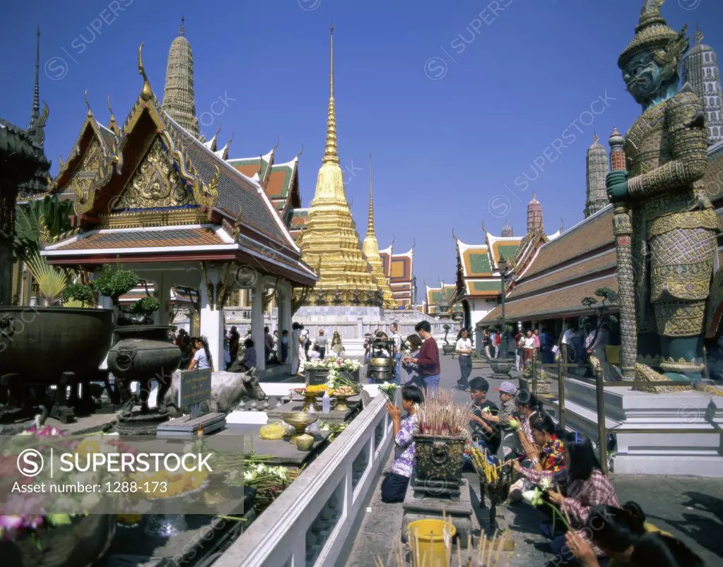 People praying in a temple, Wat Phra Kaeo, Bangkok, Thailand