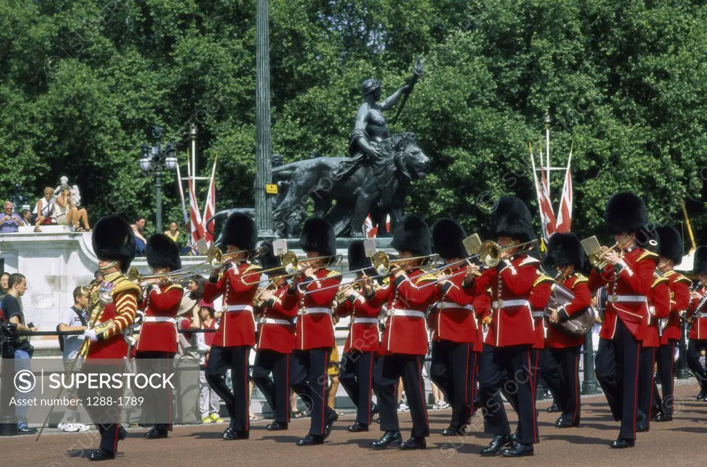Troop of British Royal Guards marching with musical instruments, Changing of the Guard, Buckingham Palace, London, England
