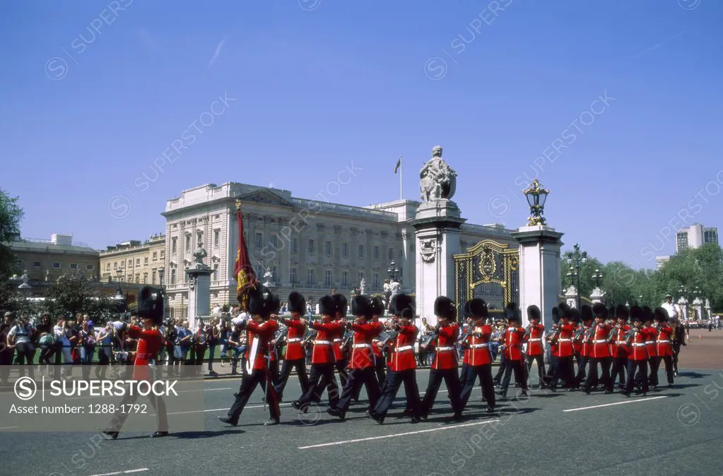 British Royal Guards marching in front of a palace, Changing of the Guard, Buckingham Palace, London, England