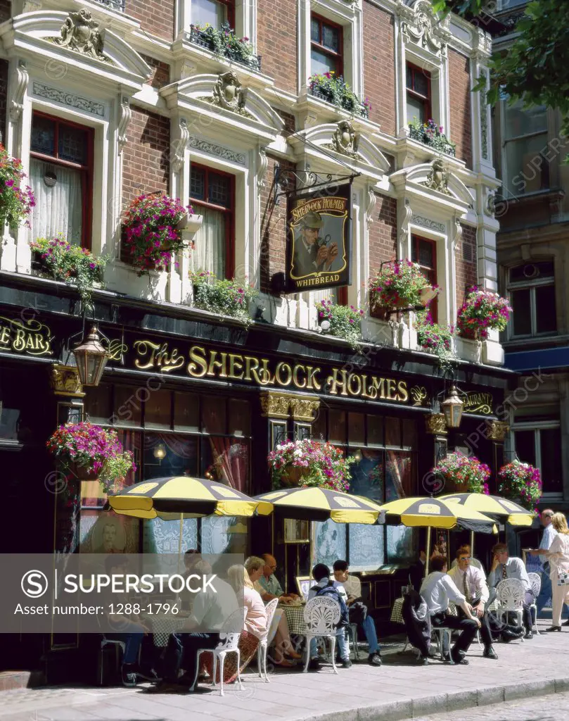 Tourists sitting at a sidewalk cafe, Sherlock Holmes Pub, London, England
