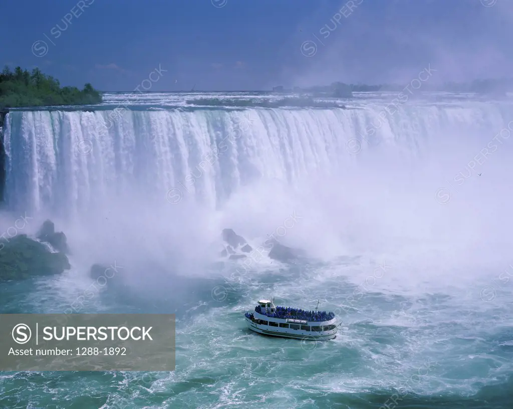 High angle view of a tourboat in front of a waterfall, Niagara Falls, Ontario, Canada
