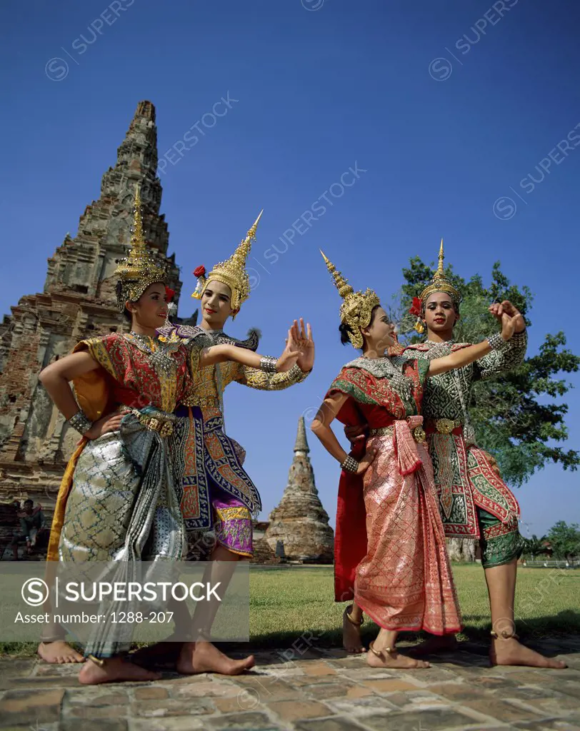 Low angle view of four young women dancing, Thailand