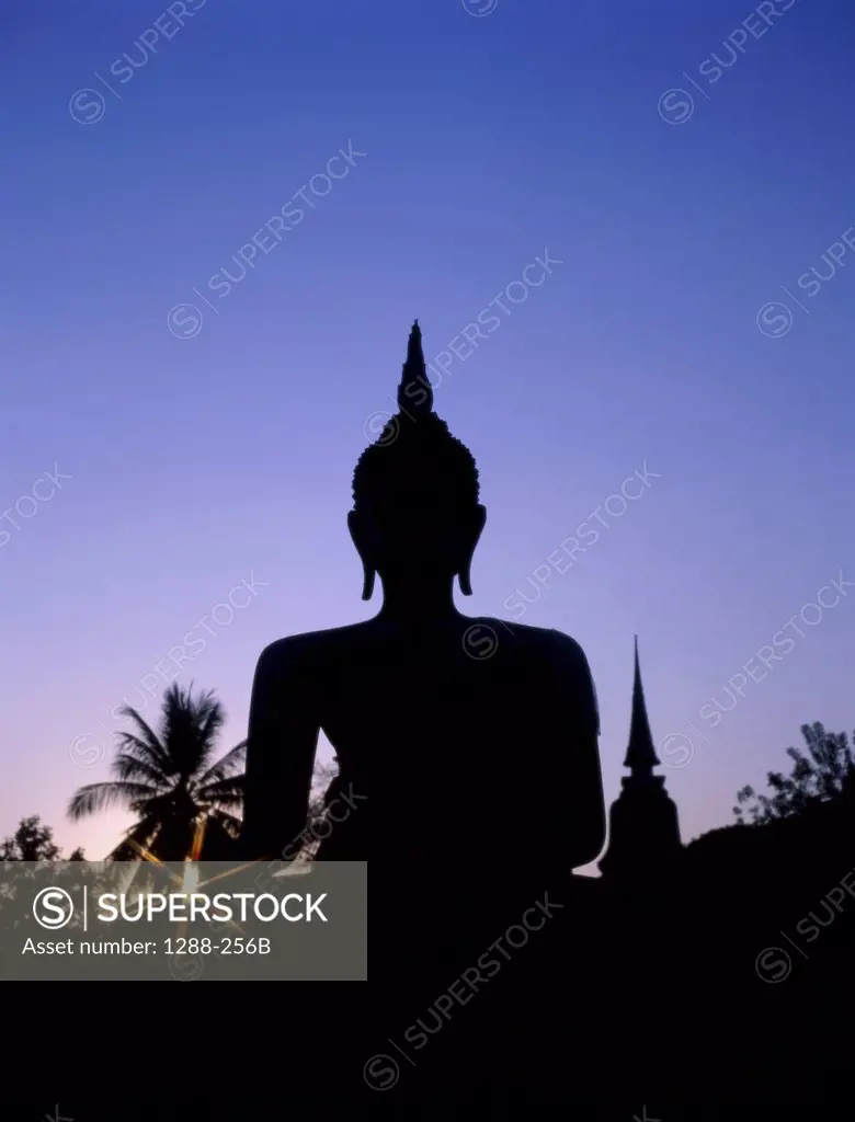 Silhouette of the statue of Buddha and temple during sunset, Sukhothai, Thailand
