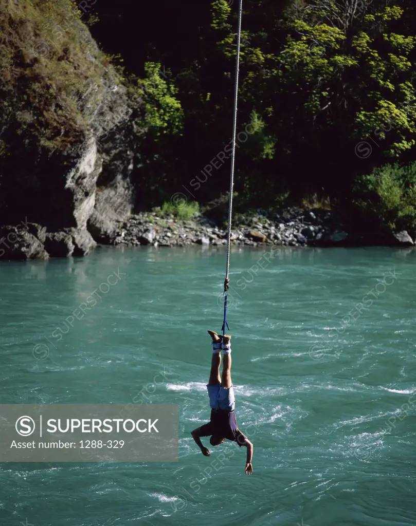 High angle view of a man bungee jumping over a river, Queenstown, New Zealand