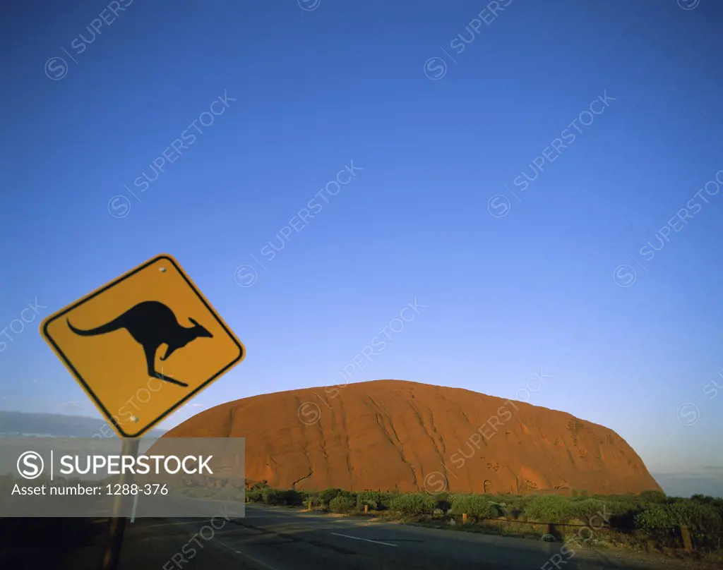 Kangaroo crossing sign on a roadside, Ayers Rock, Uluru-Kata Tjuta National Park, Australia