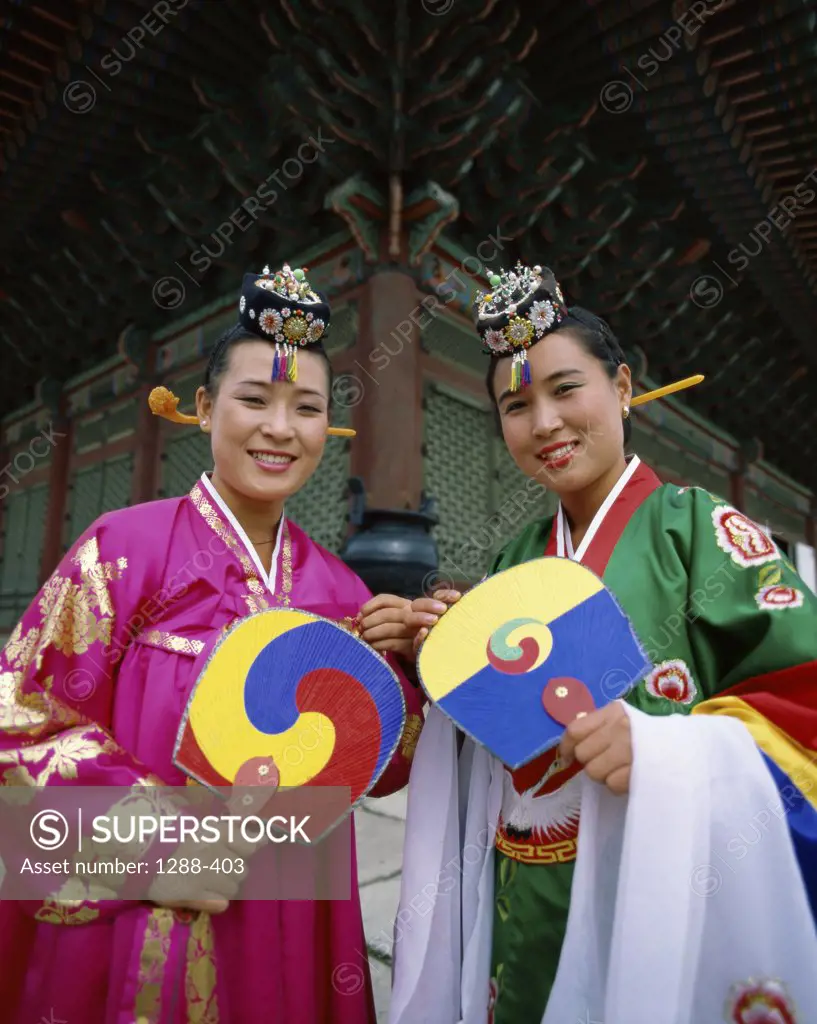 Portrait of two young women dressed in traditional clothing, South Korea